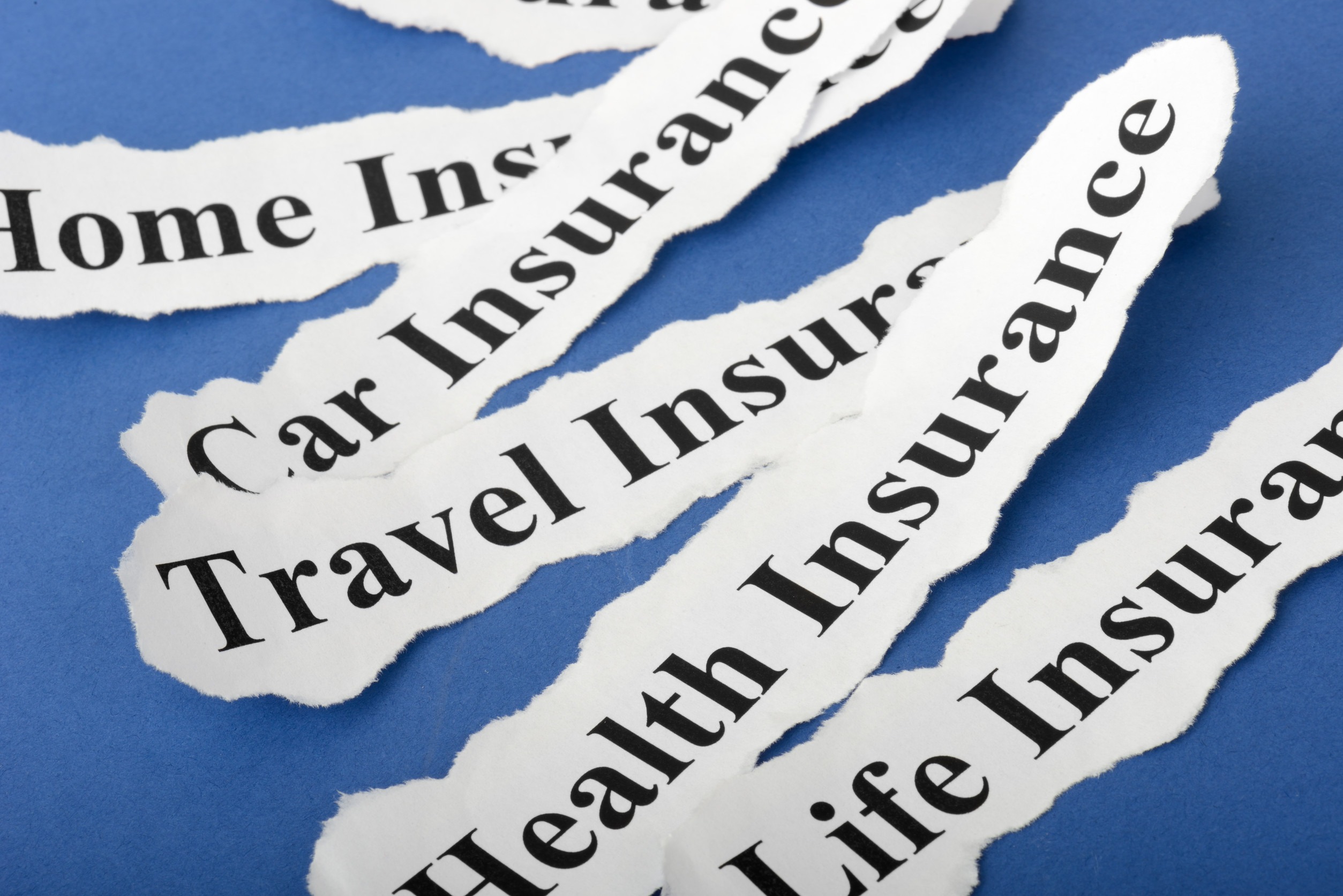 Torn paper strips with black text on a blue background, each showing different types of insurance: Home Insurance, Car Insurance, Travel Insurance, Health Insurance, and Life Insurance.